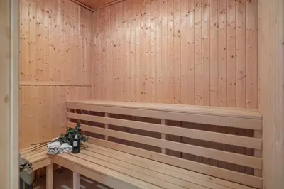 a sauna with a wooden bench in a room at Statek Luigi in Tuchlovice