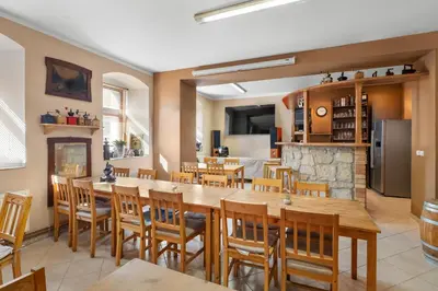 a dining room with a large table and chairs at Statek Luigi in Tuchlovice