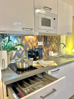 a kitchen with a sink and a stove top oven at Homely Nook Prague Centre in Prague