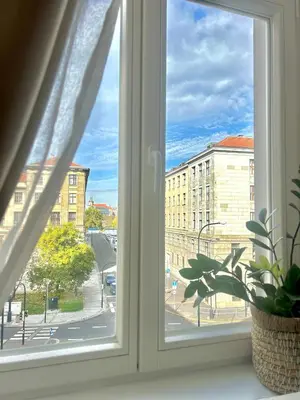 a window with a view of a city street at Homely Nook Prague Centre in Prague
