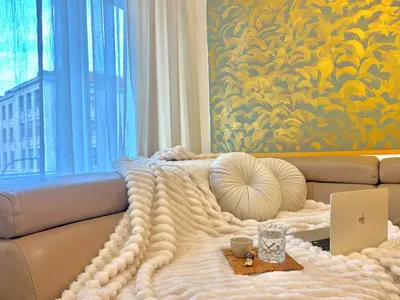 a living room with a couch with a blanket at Homely Nook Prague Centre in Prague