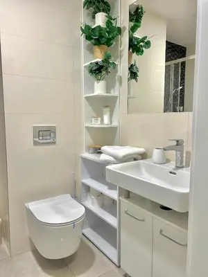 a white bathroom with a toilet and a sink at Homely Nook Prague Centre in Prague