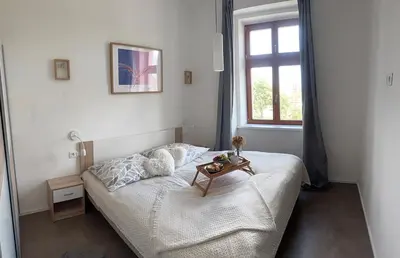 a bedroom with a bed with a table on it at One-bedroom newly renovated apartment with Netflix in Prague