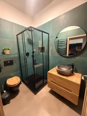 a bathroom with a shower and a sink and a mirror at One-bedroom newly renovated apartment with Netflix in Prague