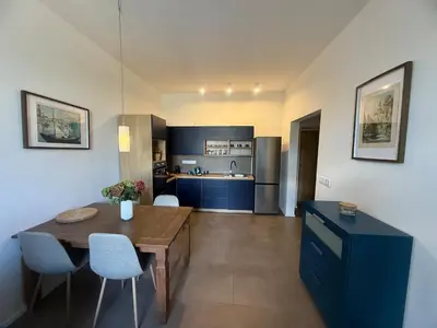 a kitchen with a wooden table and blue cabinets at One-bedroom newly renovated apartment with Netflix in Prague