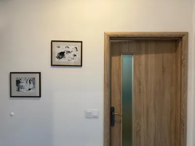 a room with a door and two pictures on the wall at One-bedroom newly renovated apartment with Netflix in Prague