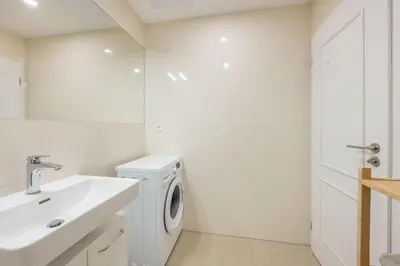 a white bathroom with a washing machine and a sink at HOMELY I Central 52m2 APT I ELEVATOR I Self Check-In in Prague