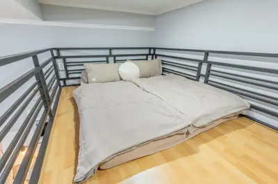a bed with pillows on top of a balcony at HOMELY I Central 52m2 APT I ELEVATOR I Self Check-In in Prague