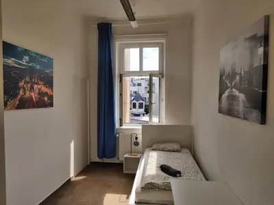 a bedroom with a bed and a window at Zizkov Stay - Near City Center in Prague