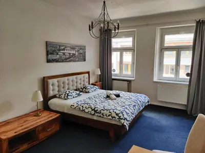 a bedroom with a bed with a teddy bear on it at Zizkov Stay - Near City Center in Prague