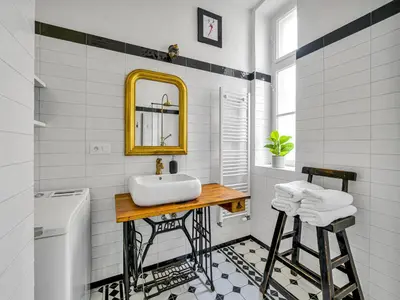 a white bathroom with a sink and a mirror at Spacious 85 sqm Apartment for Monthly Stays in Prague
