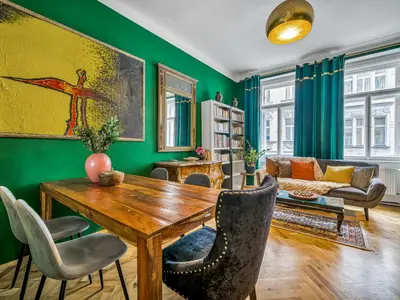 a living room with a wooden table and chairs at Spacious 85 sqm Apartment for Monthly Stays in Prague