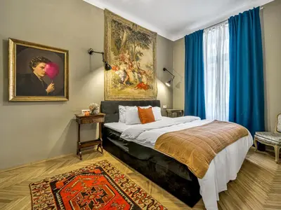 a bedroom with a bed and a painting on the wall at Spacious 85 sqm Apartment for Monthly Stays in Prague