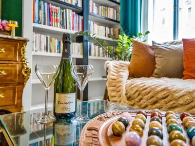 a bottle of wine and two glasses on a glass table at Spacious 85 sqm Apartment for Monthly Stays in Prague