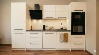 a white kitchen with white cabinets and a sink at Samaya Apartment in Litoměřice