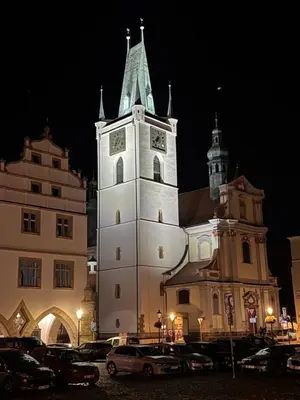 a large building with a clock tower at night at Samaya Apartment in Litoměřice