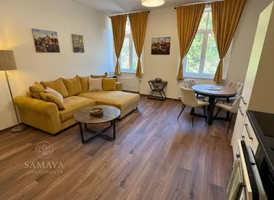 a living room with a couch and a table at Samaya Apartment in Litoměřice