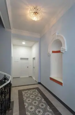 a hallway with blue walls and a chandelier at 3 Brothers Homestay Muzeum in Prague