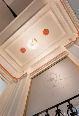 a coffered ceiling in a room with a painting on it at 3 Brothers Homestay Muzeum in Prague