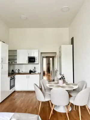 a kitchen and dining room with a table and chairs at 3 Brothers Homestay Muzeum in Prague