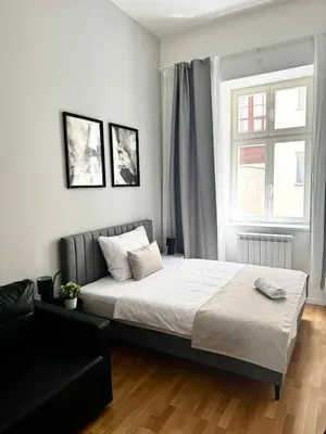 a bedroom with a bed and a window at 3 Brothers Homestay Muzeum in Prague