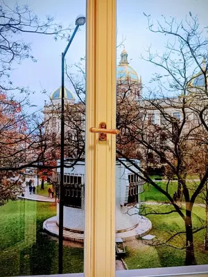 a window with a view of a building and a street light at 3 Brothers Homestay Muzeum in Prague