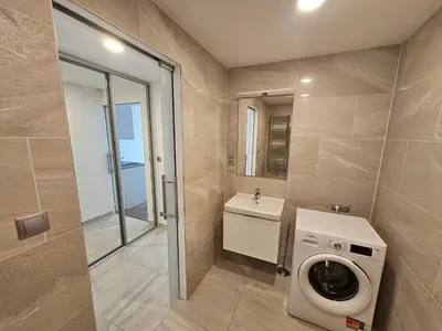 a bathroom with a washing machine and a sink at Prague Centre Luxury Apartment & Parking in Prague