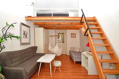 a living room with a loft bed and a couch at Cozy Apartment in Letná in Prague