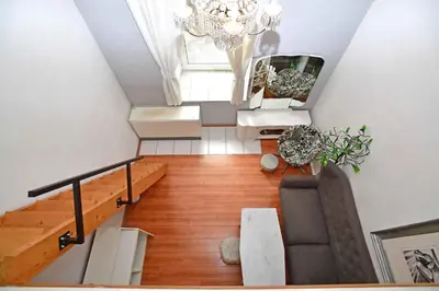 an overhead view of a living room with a chandelier at Cozy Apartment in Letná in Prague