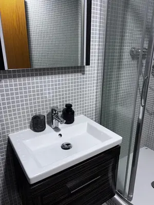 a bathroom with a white sink and a shower at Room Korunní dvur in Prague