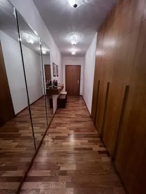 a hallway with wooden floors and a wooden door at Room Korunní dvur in Prague