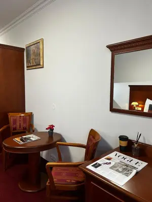 a waiting room with a table and a mirror at Vintage Apartment Old Prague Charm in Prague