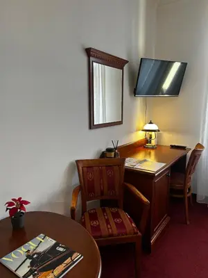 a room with a desk with a table and a mirror at Vintage Apartment Old Prague Charm in Prague