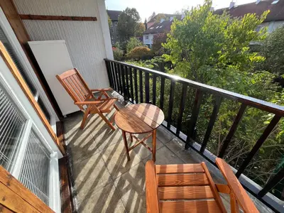 a balcony with two chairs and a table and chairs at Dům Solidarity Strašnice in Prague