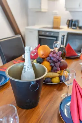a table with a bowl of fruit and a bottle of wine at Royal Prague Gallery in Prague