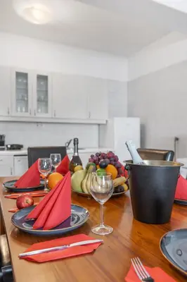 a table with plates of food and wine glasses on it at Royal Prague Gallery in Prague