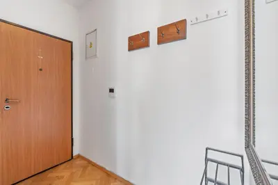 a room with a wooden door and a chair at Royal Prague Gallery in Prague