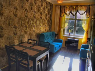a dining room with a table and chairs and a window at Stela's Apartments - Vysehrad in Prague