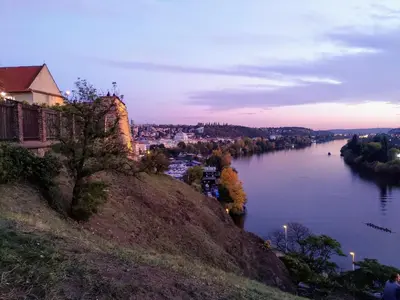 a view of a river from a hill at dusk at Stela's Apartments - Vysehrad in Prague