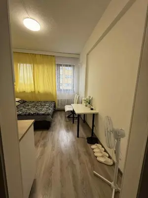 a small room with a table and a bed and a desk at Ethereal Haven 1 in Prague