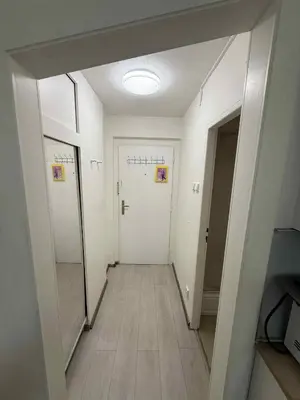 an empty hallway with white walls and a white door at Ethereal Haven 1 in Prague