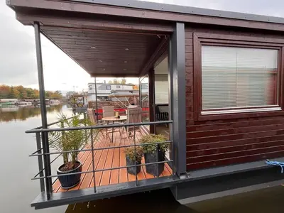 a house on the water with a balcony at Houseboat Rosie in Prague