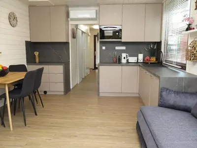 a kitchen and living room with a table and a couch at Houseboat Rosie in Prague