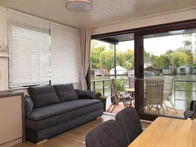 a living room with a couch and a table at Houseboat Rosie in Prague