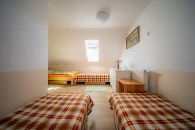 two beds in a room with two beds in it at Ubytování Hrusice in Hrusice