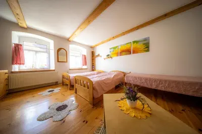 a room with two beds and a table in it at Ubytování Hrusice in Hrusice