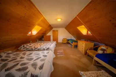 a bedroom with two beds in a attic at Ubytování Hrusice in Hrusice