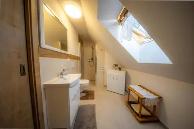 a bathroom with a sink and a skylight at Ubytování Hrusice in Hrusice