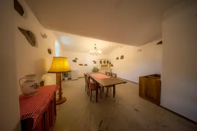 a dining room with a table and a lamp at Ubytování Hrusice in Hrusice