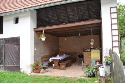 a patio with a table and a bench on a house at Ubytování Hrusice in Hrusice